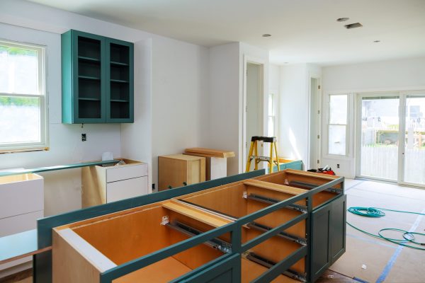 Custom kitchen cabinets in various stages of installation base for island in center Installation of kitchen cabinets